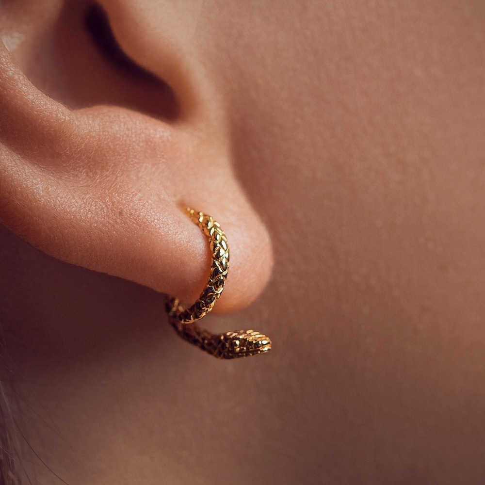 Refined twisted snake earrings. Can be positioned facing a variety of ways; NWOT